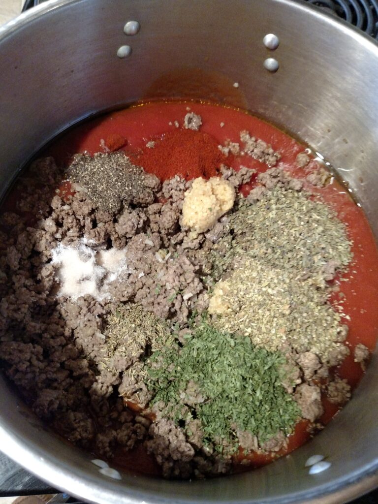 looking down into the pot after adding the ingredients for freezer spaghetti sauce