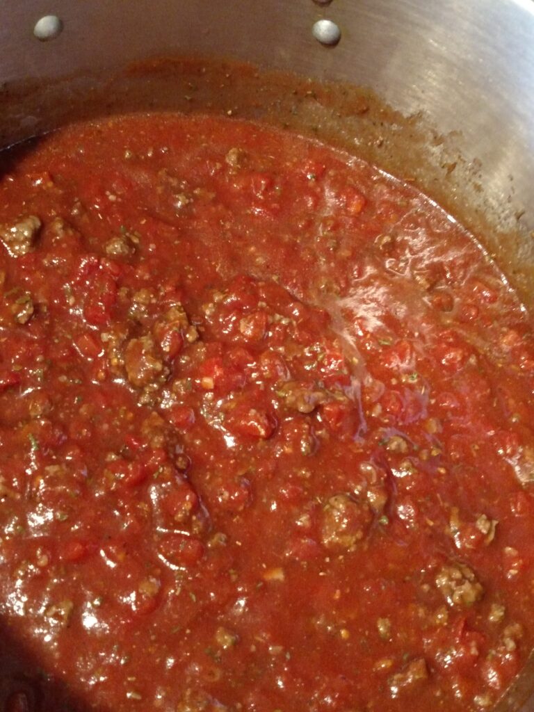 looking down into a large pot of freezer spaghetti sauce