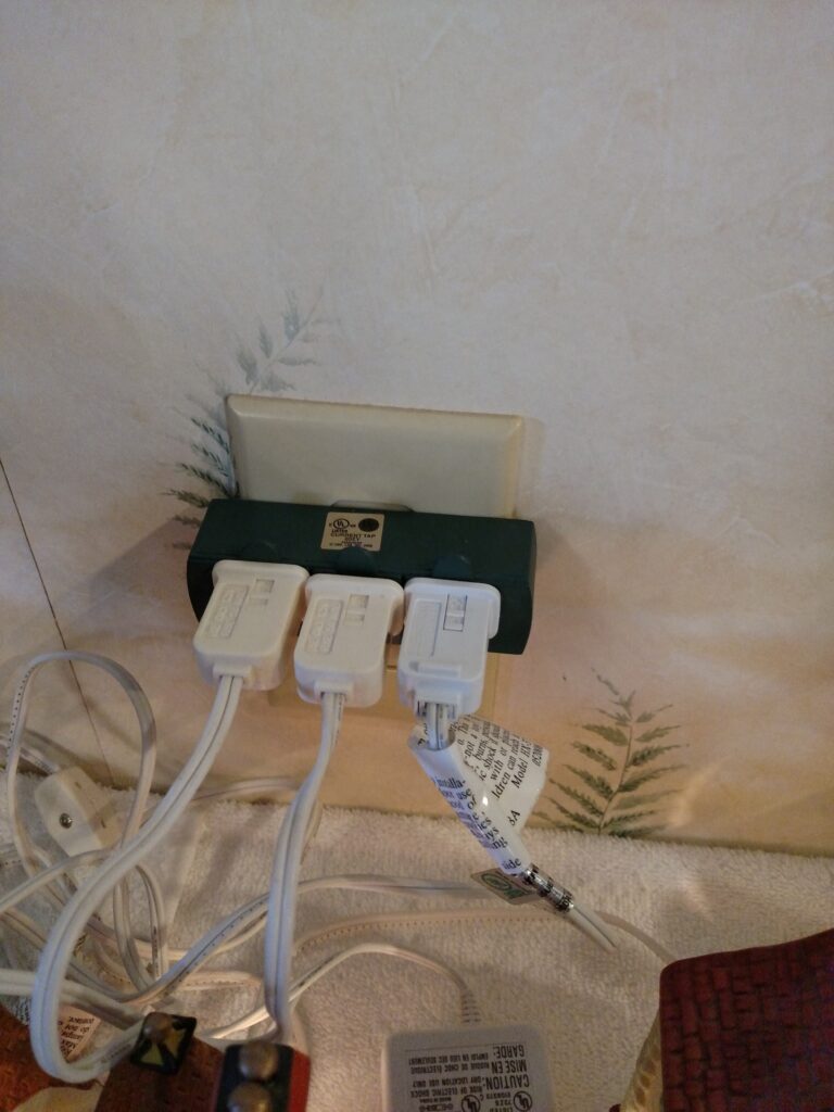 3 plugs plugged into wall outlet that holds 3