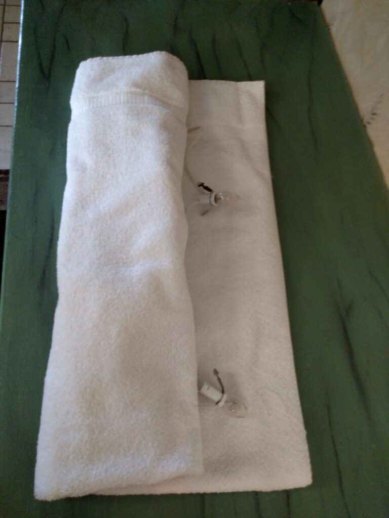 folding up the towel with the village cord inside