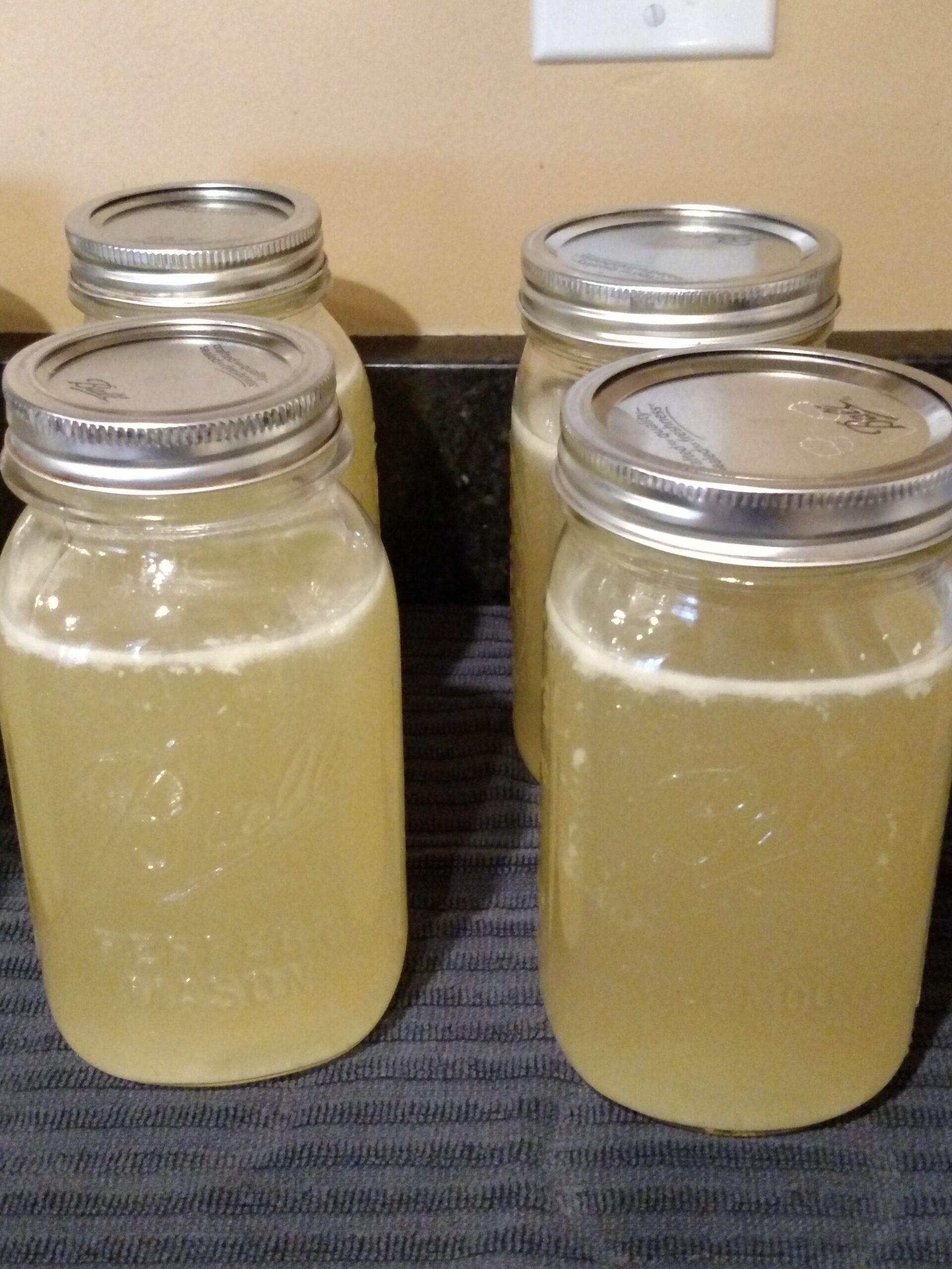 4 jars of home canned chicken broth quarts.