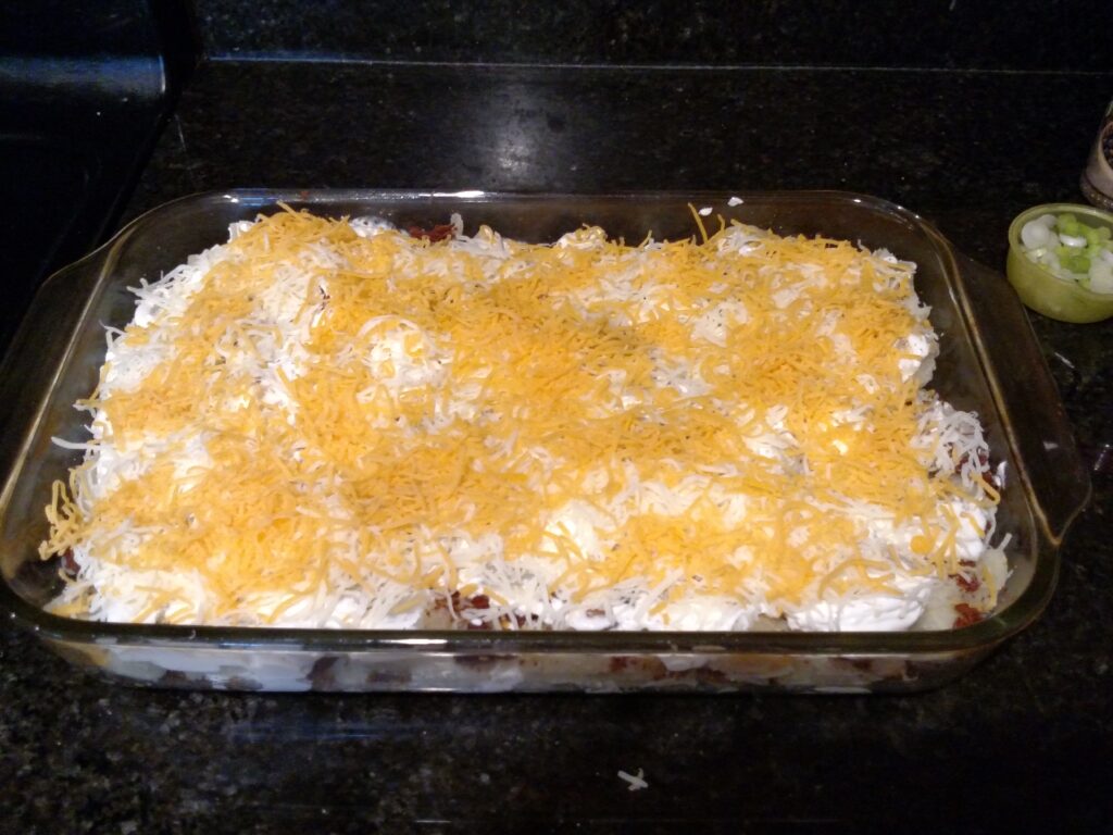 more cheese added to sour cream layer.