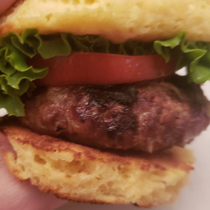 A Best Low Carb Burger in someone's hand ready to eat.