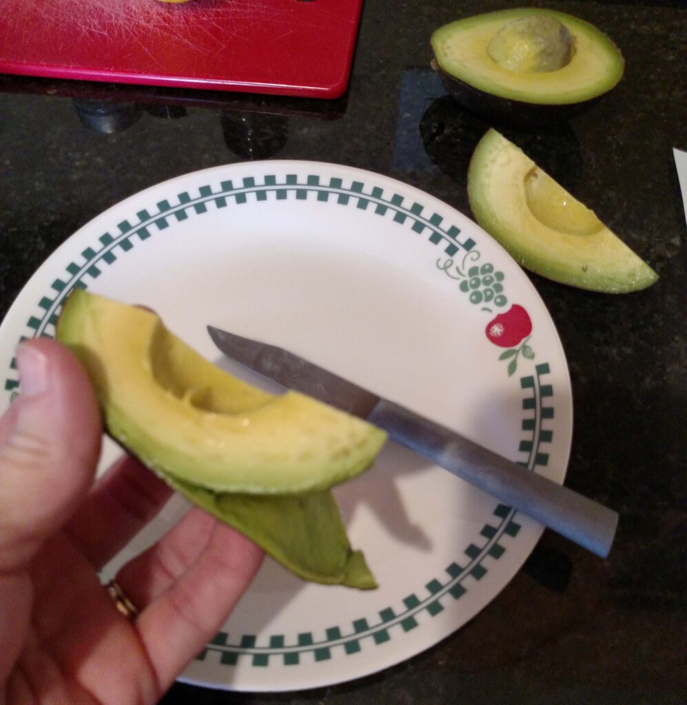 cutting an avocado into quarters