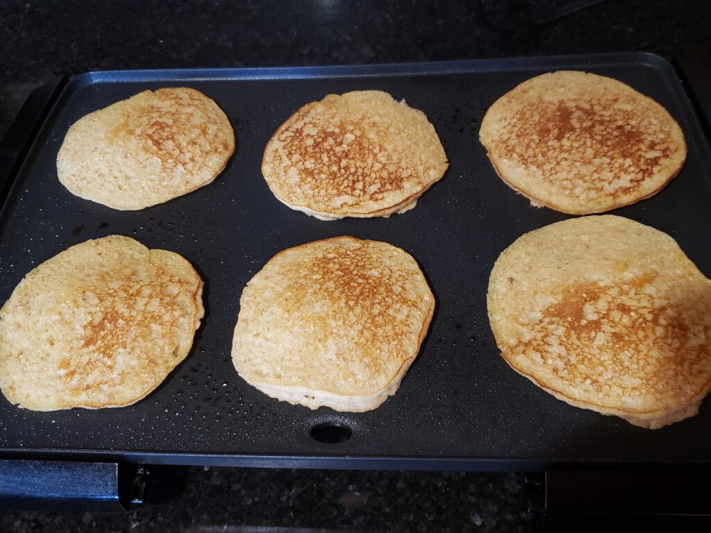 6 nicely browned pancakes on griddle