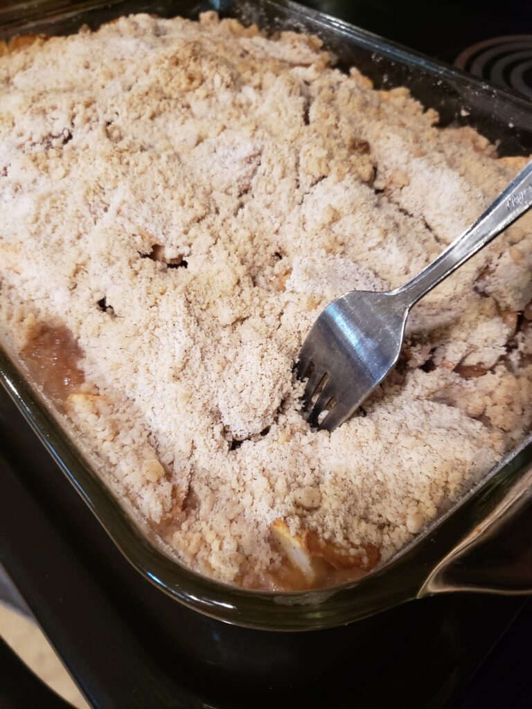 testing apple crisp with fork to see if it is cooked