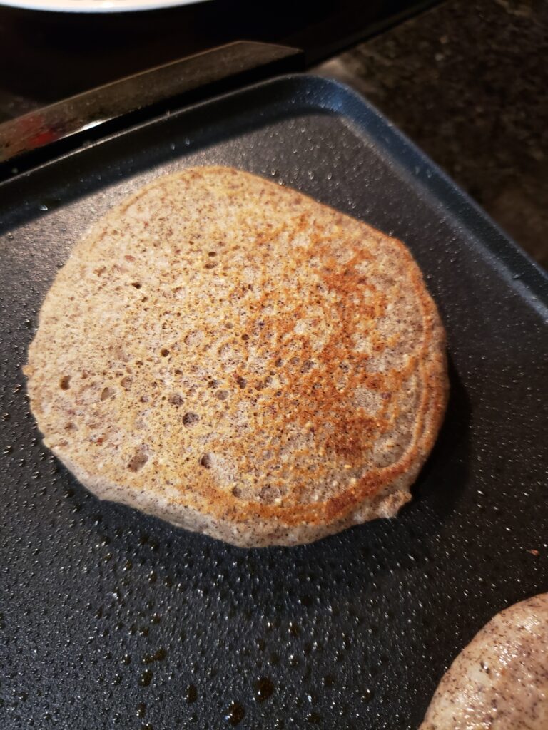 one perfectly browned pancake on griddle