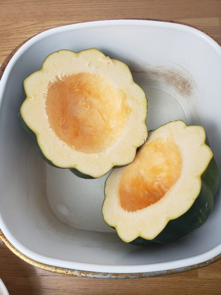 acorn squash cut in half in slow cooker