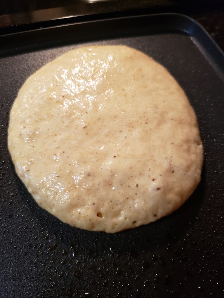 1 pancake on griddle ready to flip.