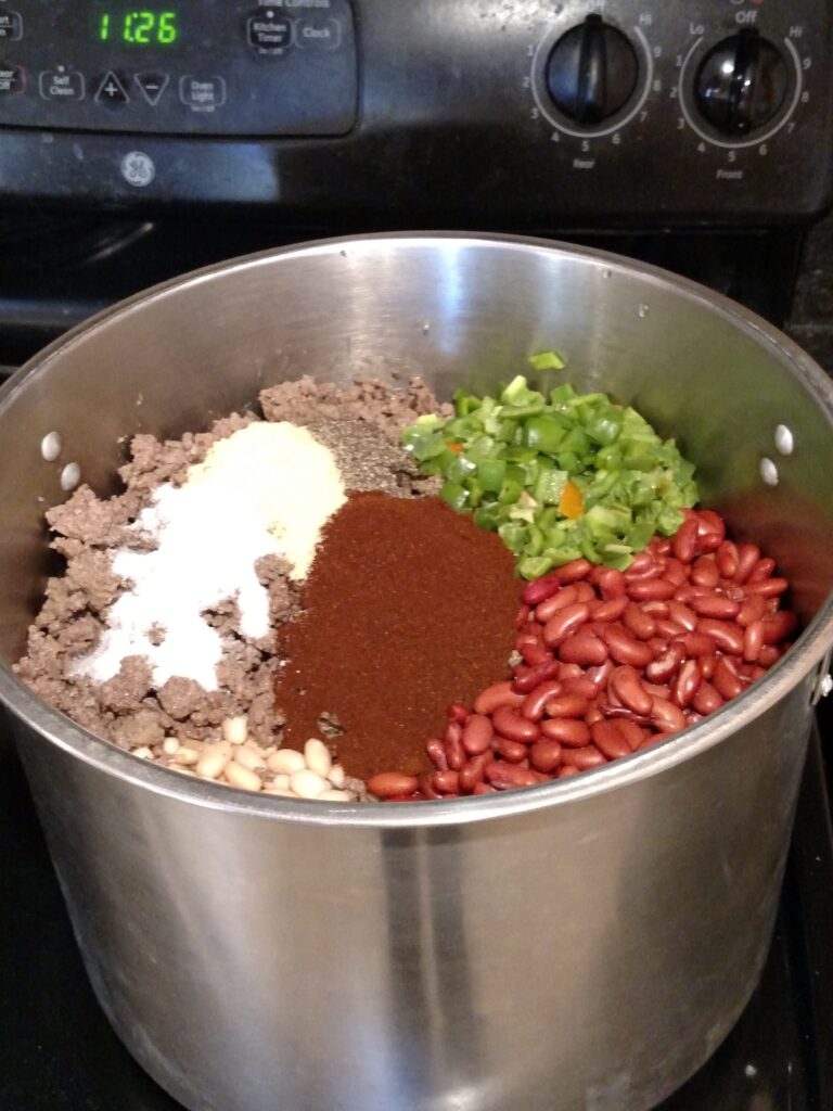 big batch homemade chili in pot before stirring together