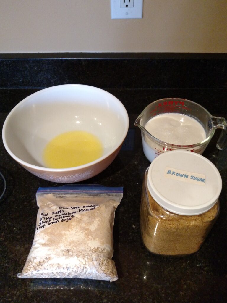 Brown Sugar Oatmeal Pancake mix in Ziploc bag, brown sugar, buttermilk and melted butter in bowl