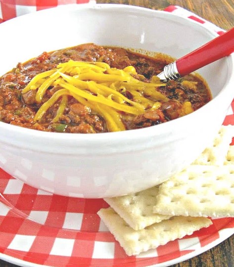 8 hour chili in while bowl on red and white checkered plate