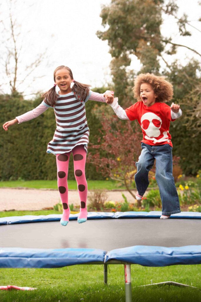 boy and girl jumping on trampoline