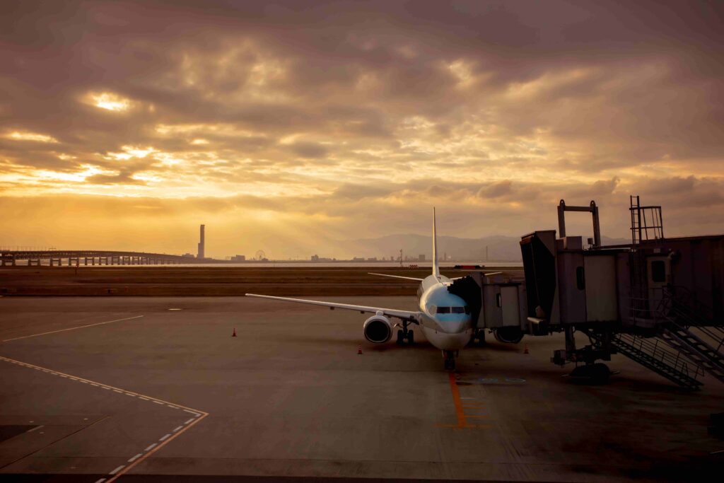 airplane next to passenger walkway at airport