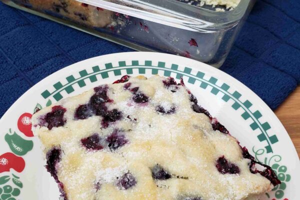 Overnight Blueberry Coffee Cake Overnight Blueberry Coffee Cake with a piece on plate in front of baking dish