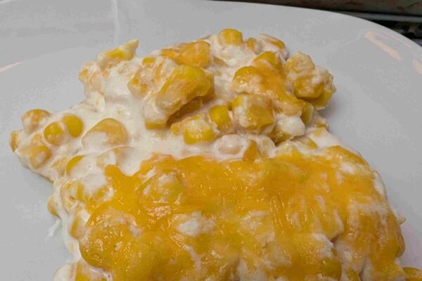Cheesy Corn Casserole a serving of cheese corn casserole on a white plate
