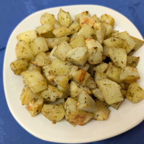 Oven Roasted Ranch Potato Bites on a white plate on a blue napkin