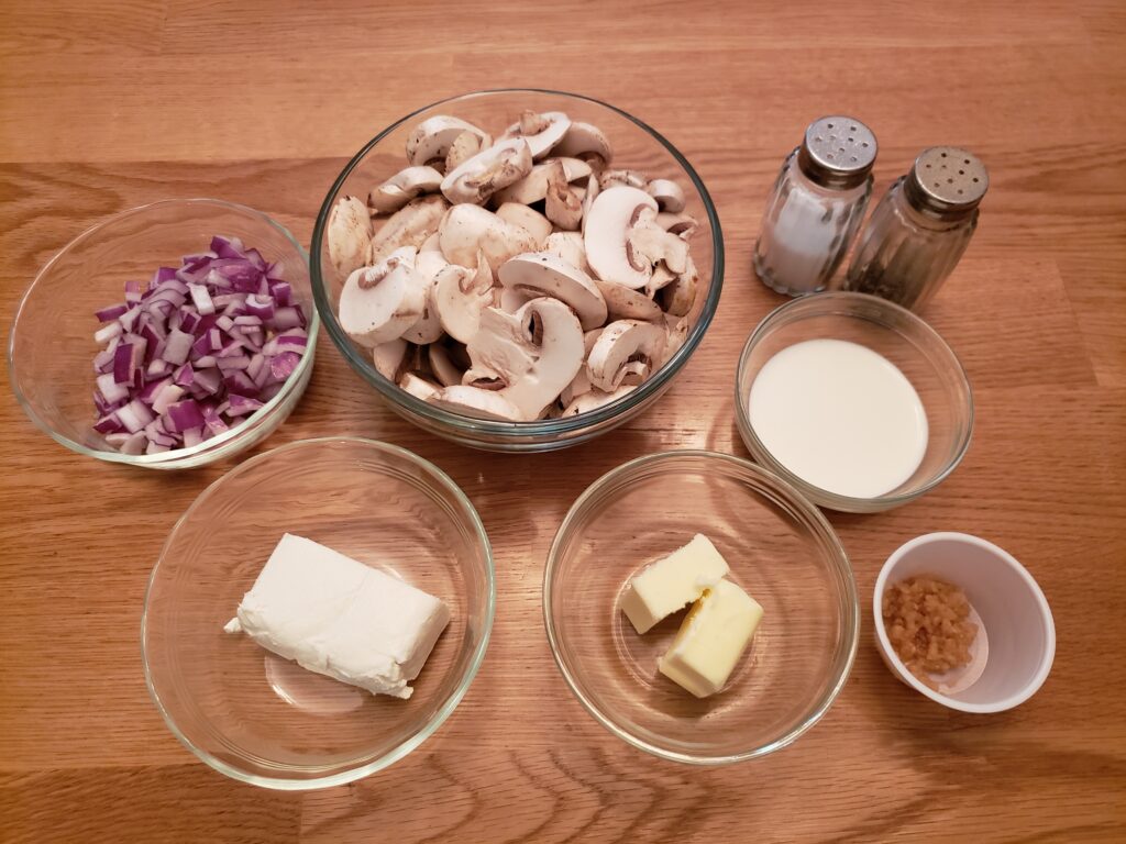 ingredients for creamed mushrooms in individual bowls