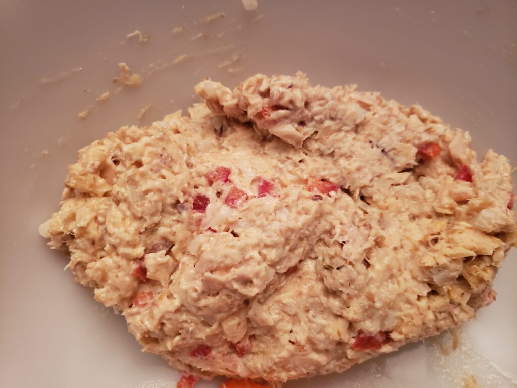 ingredients for gluten free salmon cakes mixed together in bowl