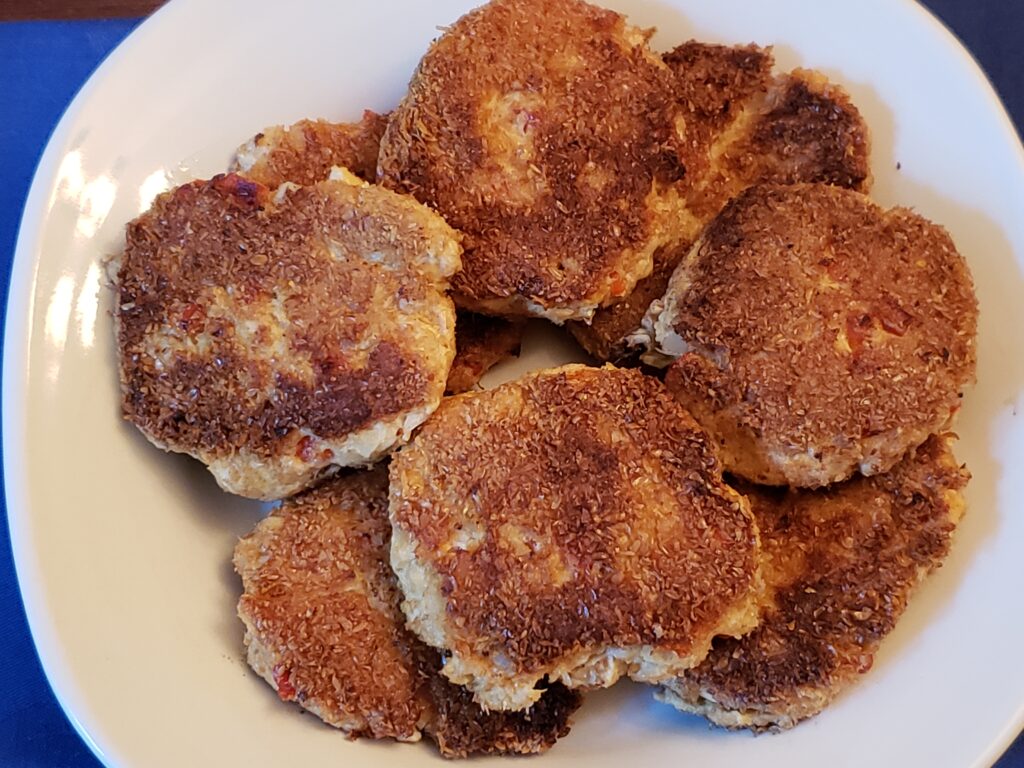 gluten free salmon cakes piled on a white plate