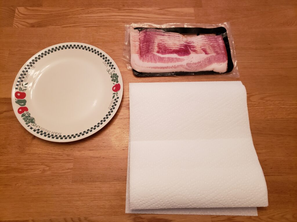 package of bacon, plate and paper towels