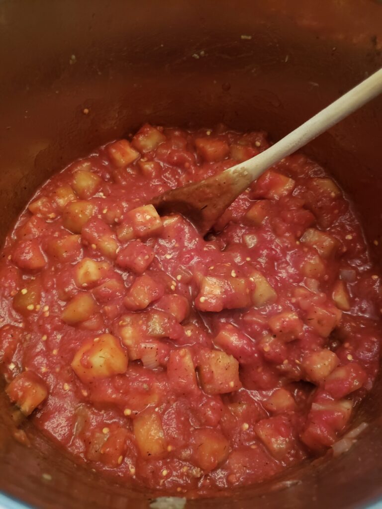 stirring in tomato sauce