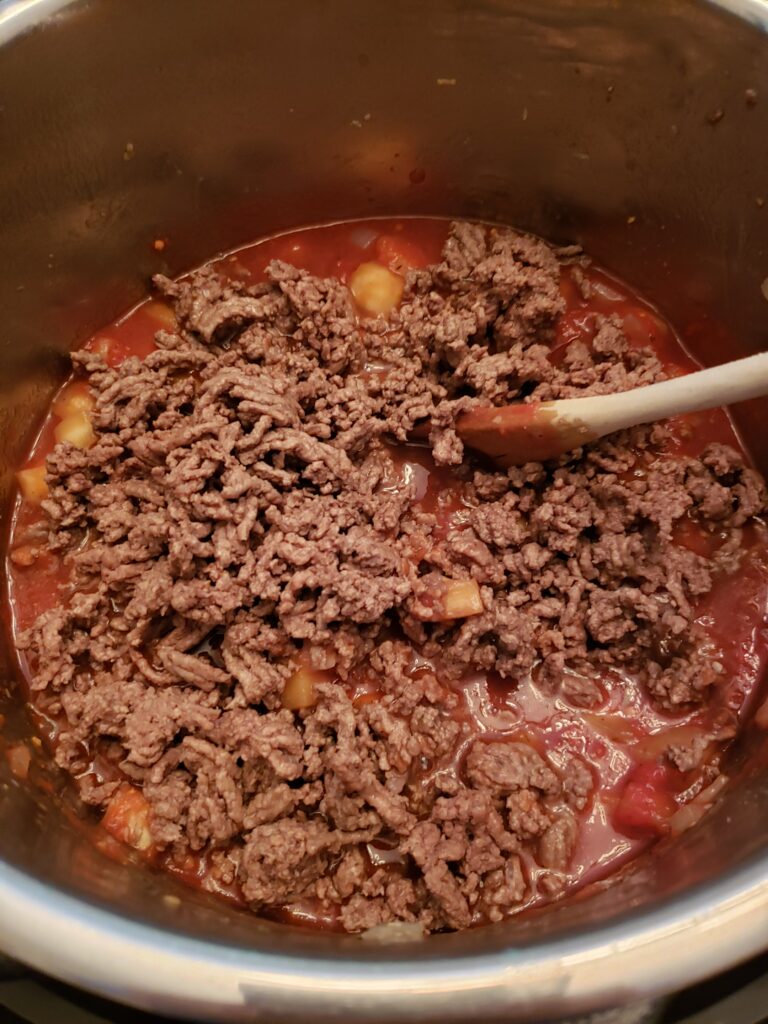 added in meat and stirring in sauce