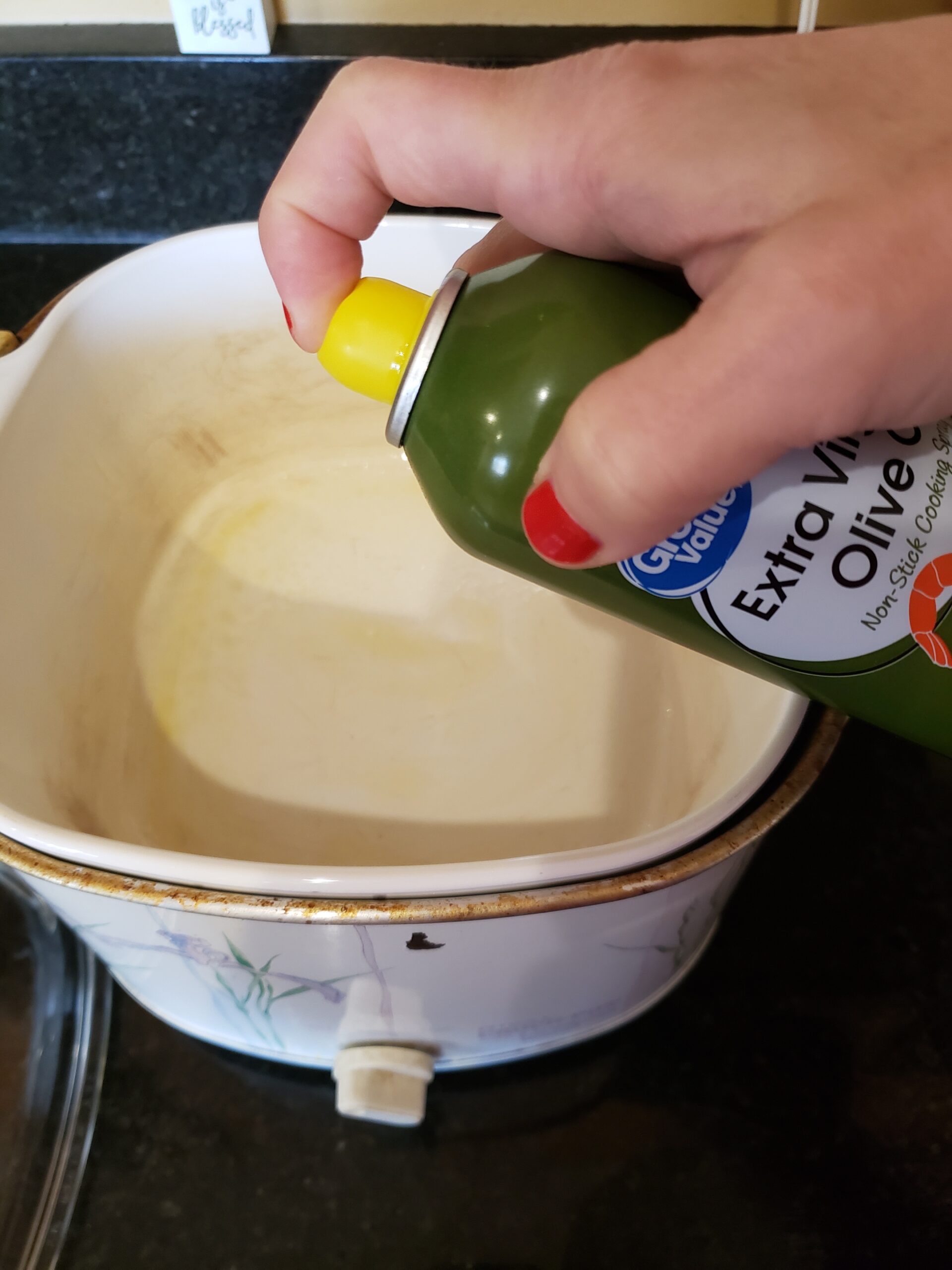 spraying the slow cooker