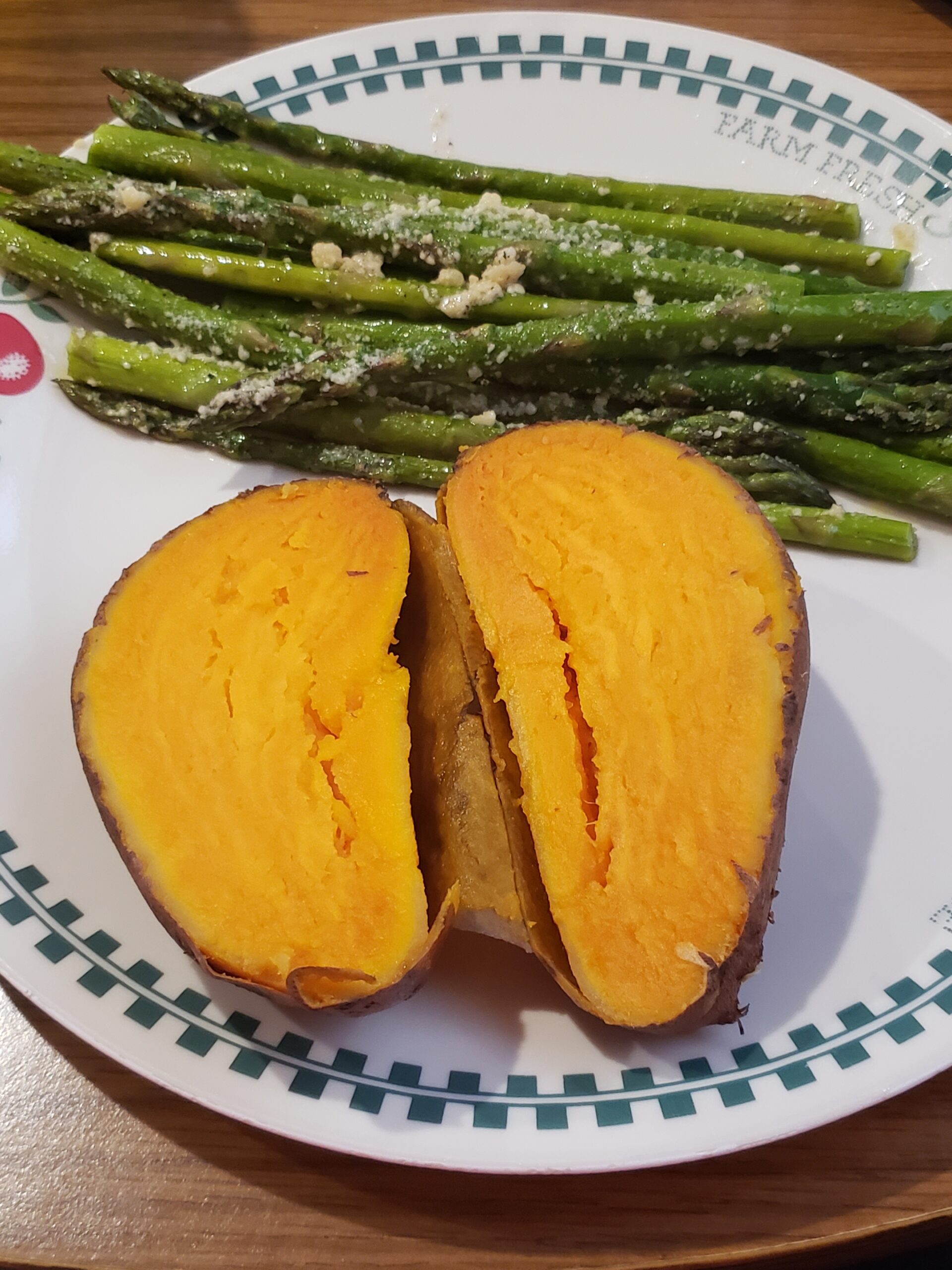 sweet potato cut in half on plate with asparagus