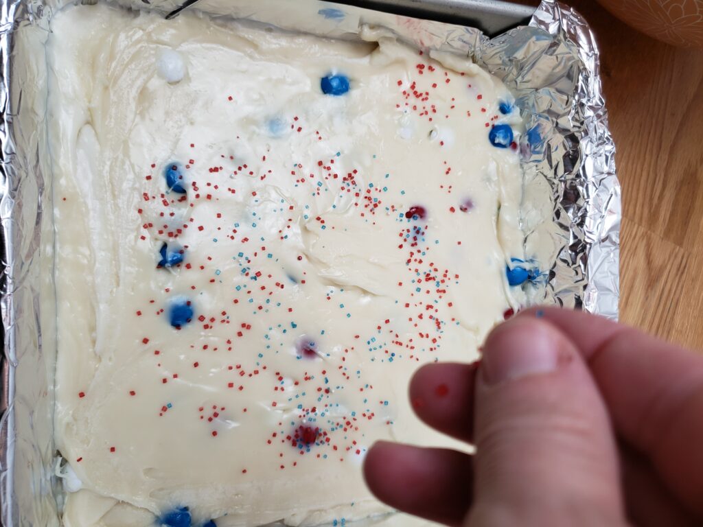 sprinkling sugar on top of the fudge