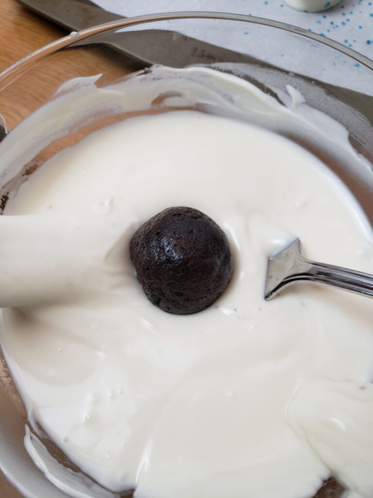 dripping truffle into melted white chocolate