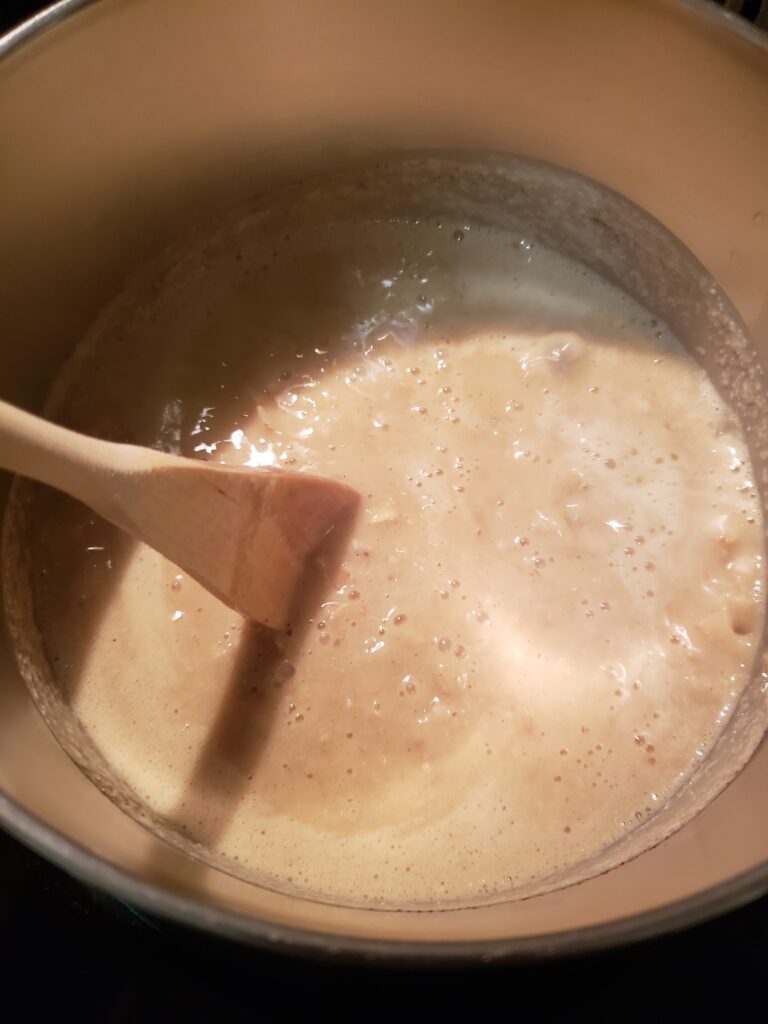 stirring water, milk, oats, pumpkin and pumpkin pie spice in saucepan