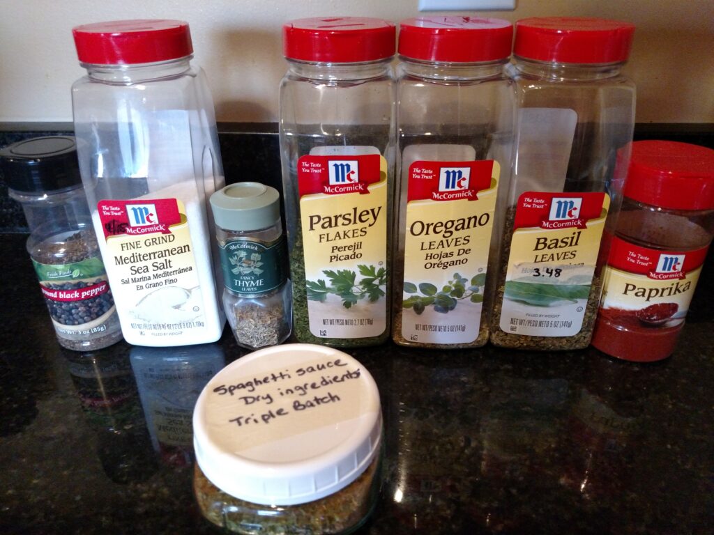 spices for spaghetti sauce lined up on counter