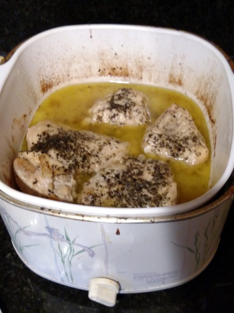 crock pot garlic herb chicken in crock pot after cooking
