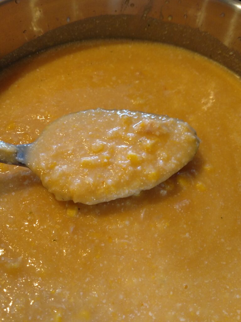 chicken corn chowder with some on spoon to show thickness
