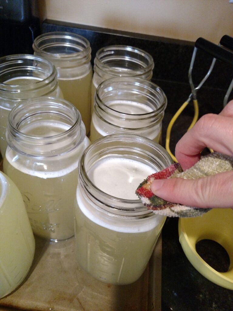 wiping jar tops with cloth