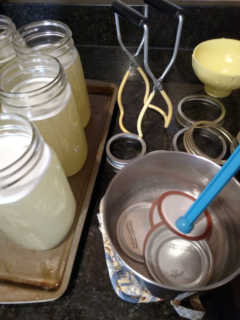 taking lids from pan of hot water