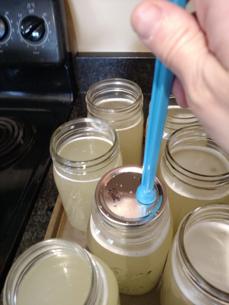 putting lid on canning jar