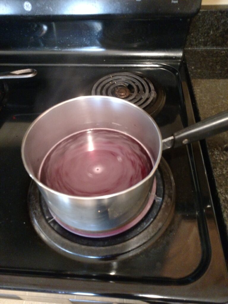 beet juice and water in pan on stove