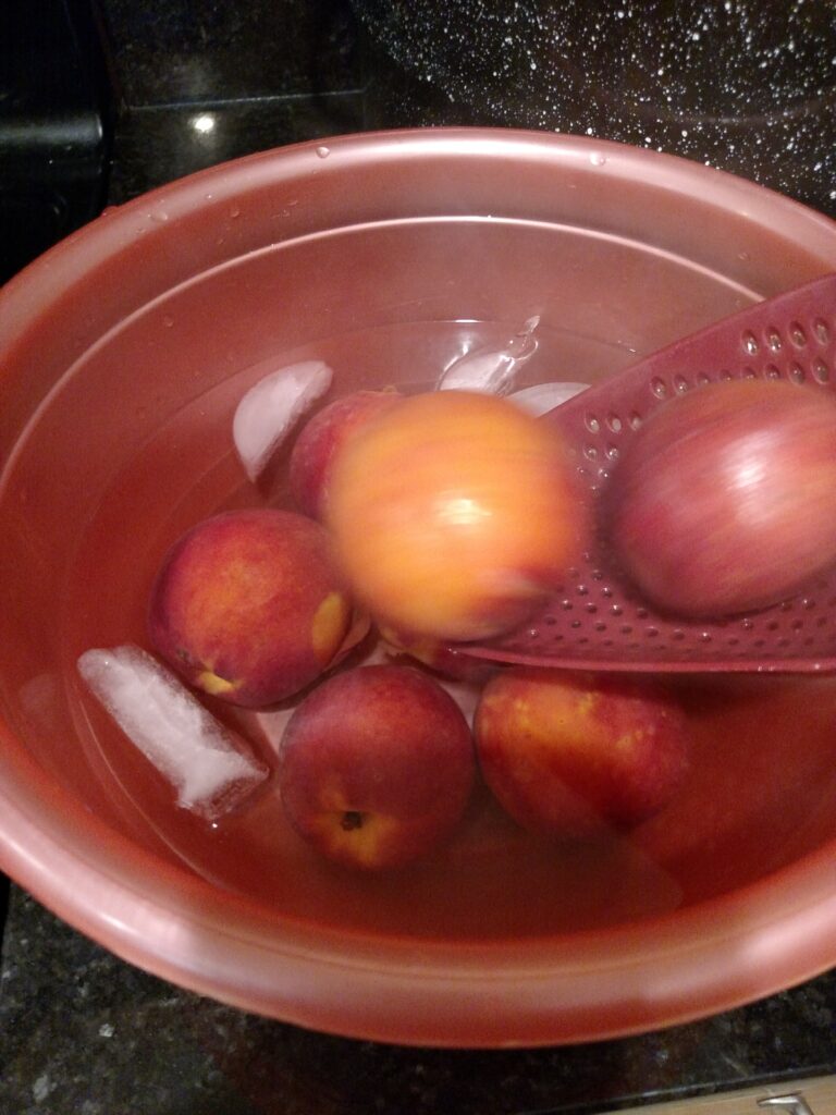 adding peaches to ice water