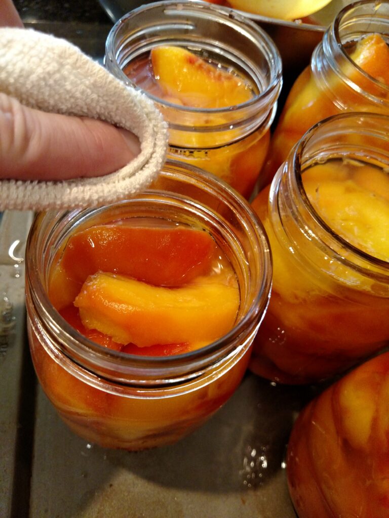 wiping jar tops with cloth