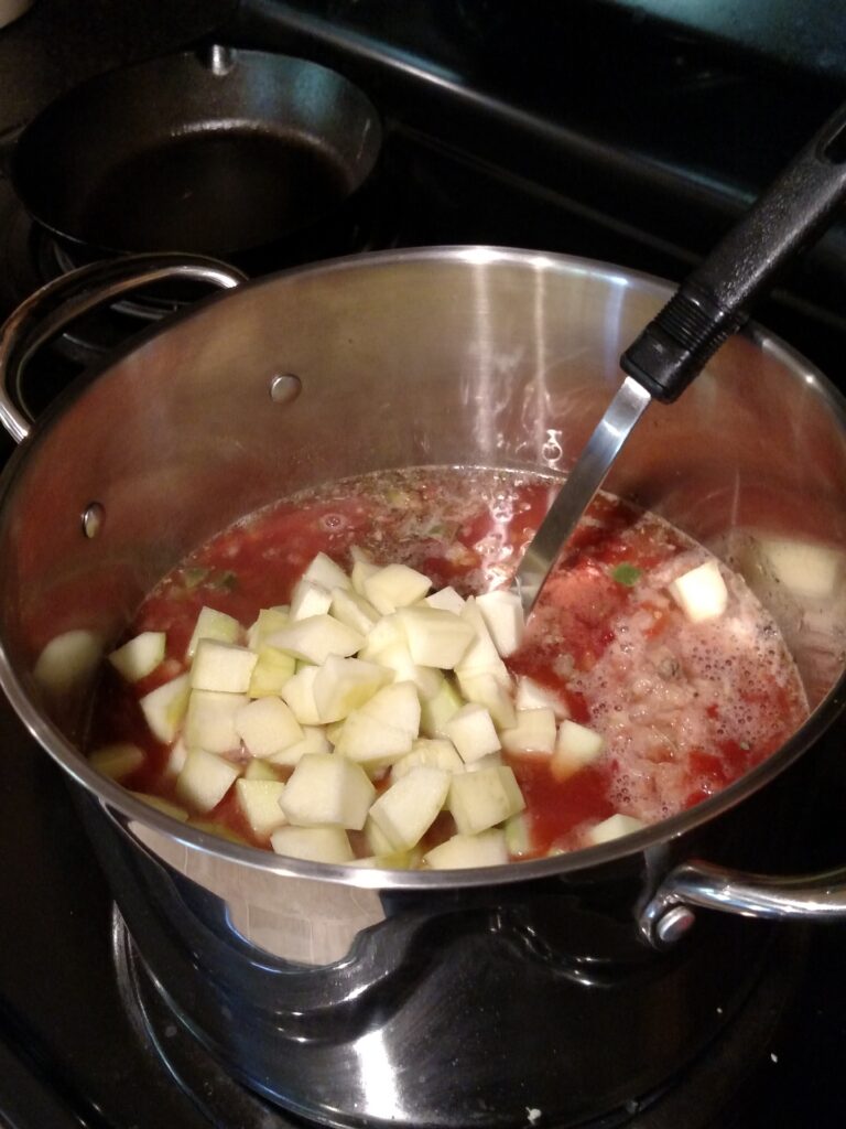 sausage zucchini soup in saucepan on stove