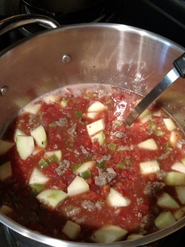 sausage zucchini soup in saucepan on stove