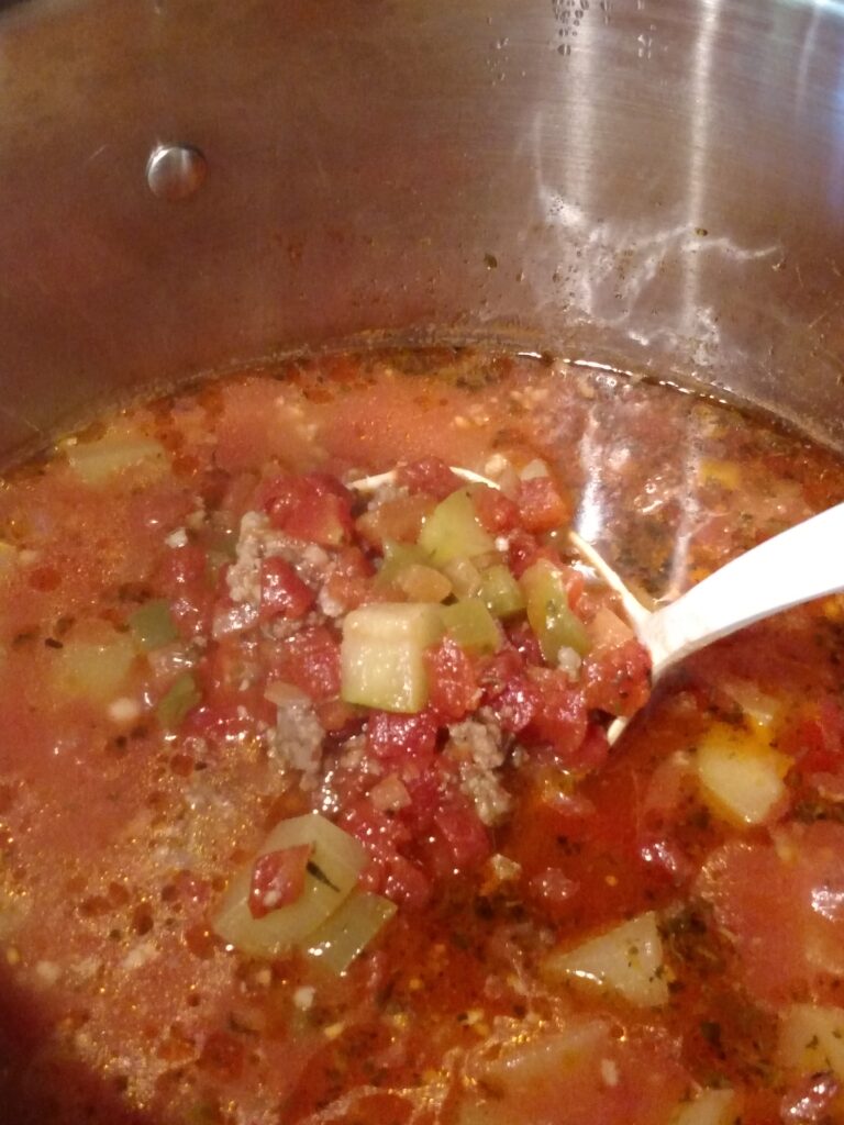 sausage zucchini soup in saucepan on stove
