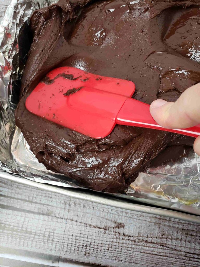smoothing out fudge in foil lined pan