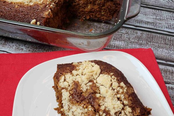 Shoo Fly Cake on serving plate next to baking pan