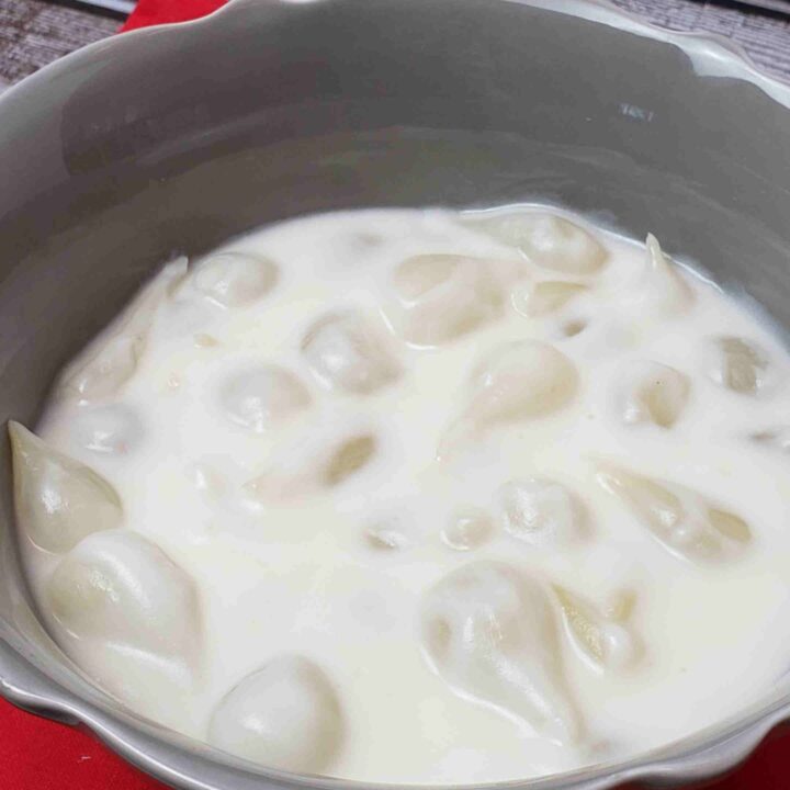 creamed onions in gray serving bowl