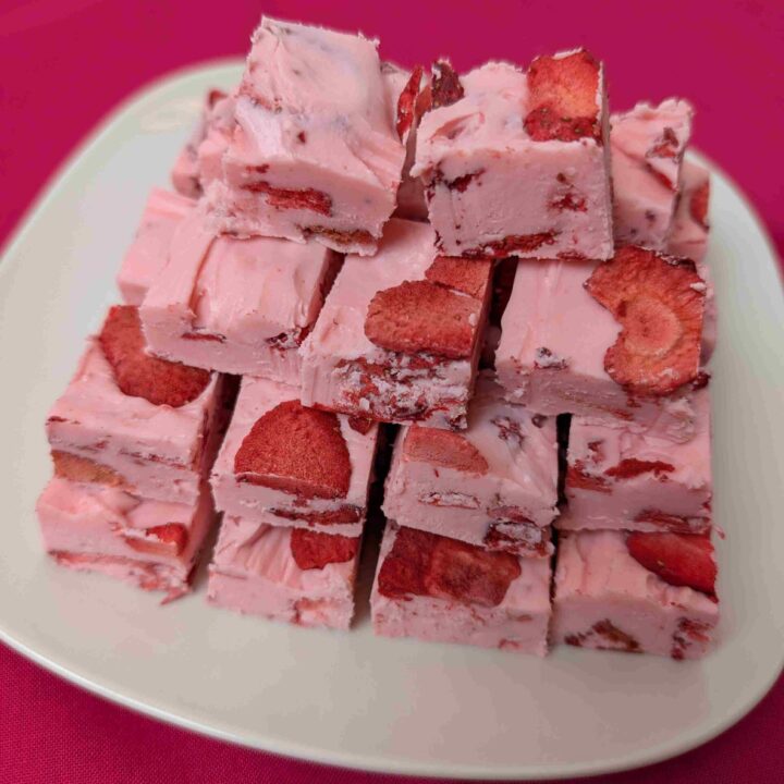 easy strawberry fudge on a white plate and dark pink napkin