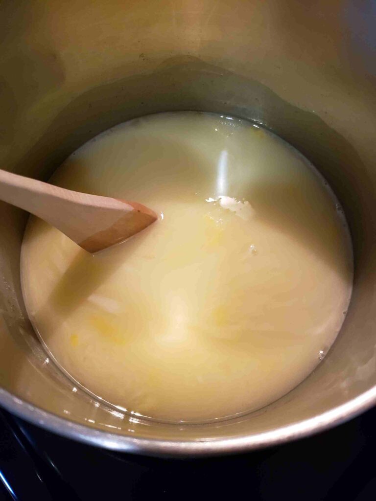 stirring ingredients for vintage lemon butter in saucepan