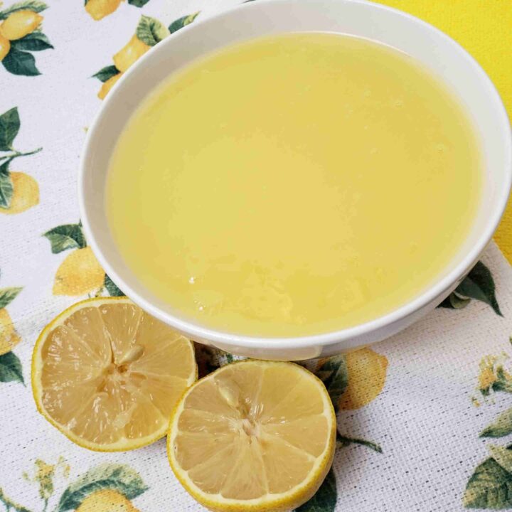 vintage lemon butter in white bowl with lemon tea towel under it